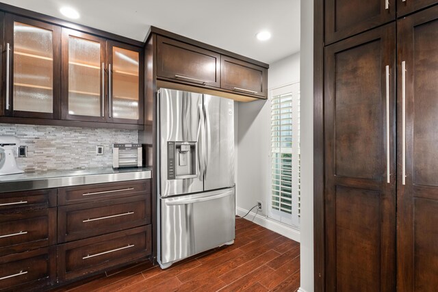 kitchen with backsplash, dark hardwood / wood-style floors, dark brown cabinetry, island exhaust hood, and stainless steel dishwasher