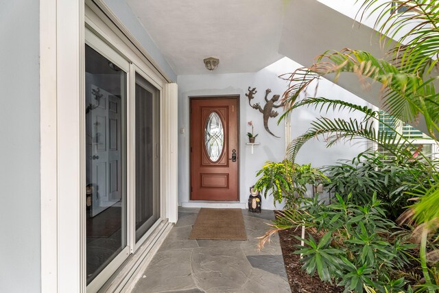 unfurnished sunroom with ceiling fan