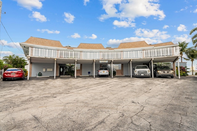 view of vehicle parking with a carport