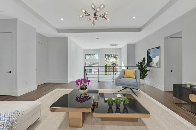 kitchen featuring tasteful backsplash, white cabinetry, stainless steel appliances, light wood-type flooring, and wall chimney exhaust hood