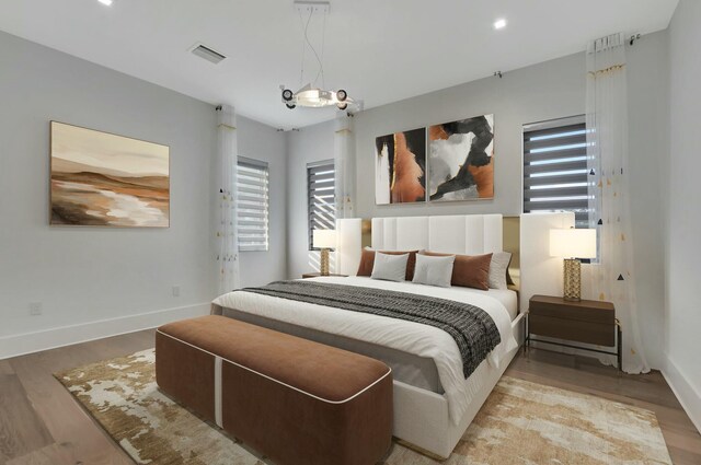 home office with a raised ceiling and light hardwood / wood-style flooring