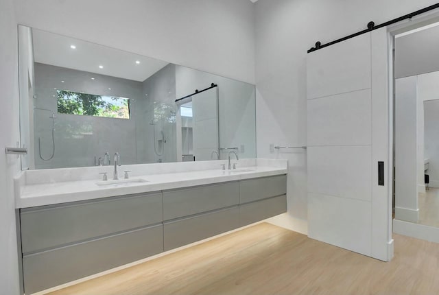 bathroom with vanity, hardwood / wood-style floors, and a tile shower