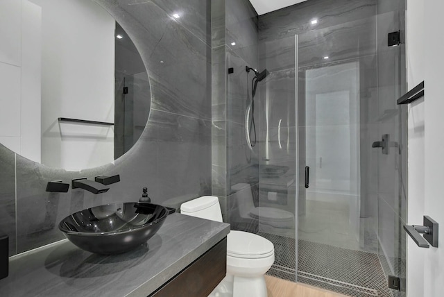 bathroom with vanity, an enclosed shower, and toilet