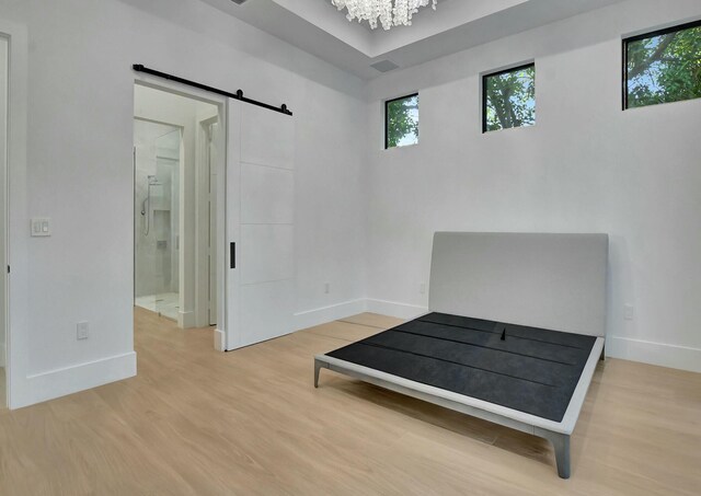 spare room featuring a tray ceiling, dark hardwood / wood-style flooring, and a notable chandelier