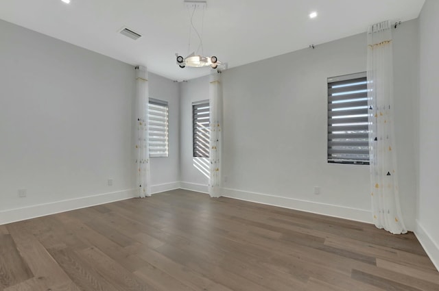 unfurnished room with hardwood / wood-style floors