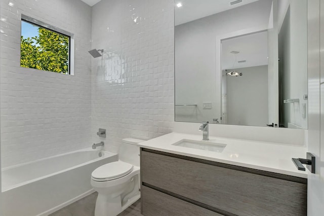 full bathroom featuring vanity, toilet, and tiled shower / bath combo