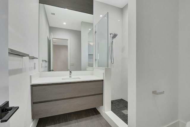 bathroom featuring vanity and a tile shower