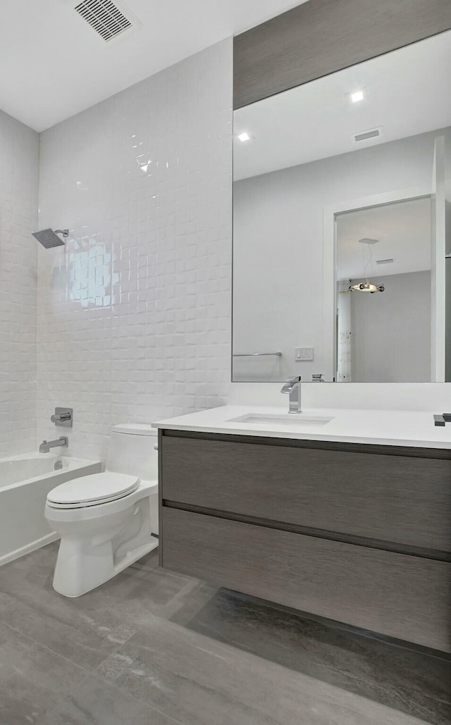 full bathroom featuring vanity, toilet, and tiled shower / bath combo