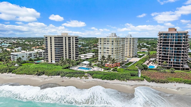 view of property featuring a water view and a beach view