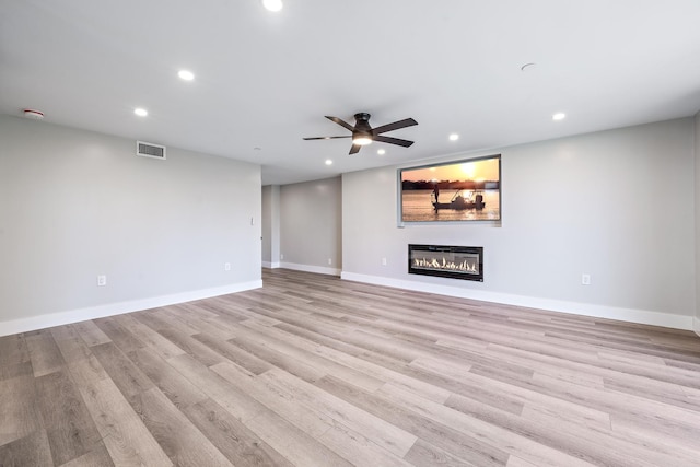 unfurnished living room with ceiling fan and light hardwood / wood-style floors