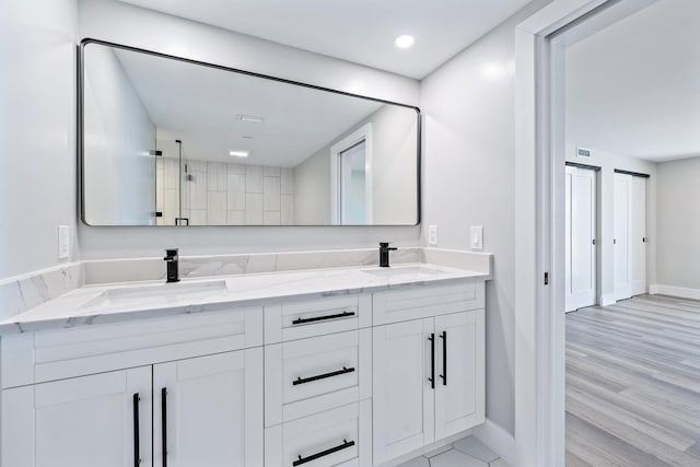 bathroom featuring hardwood / wood-style flooring and vanity