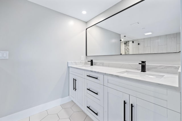 bathroom with tile patterned flooring, vanity, and a shower