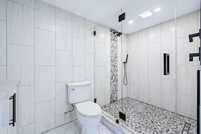 bathroom with tile walls, an enclosed shower, and toilet