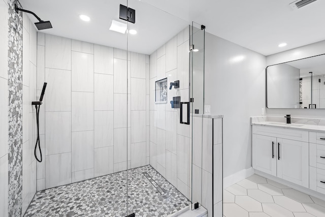 bathroom with tile patterned floors, vanity, and a shower with shower door