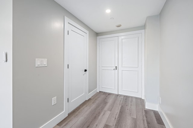 hallway with light hardwood / wood-style flooring