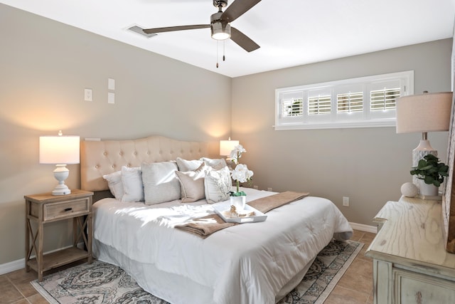 tiled bedroom featuring ceiling fan