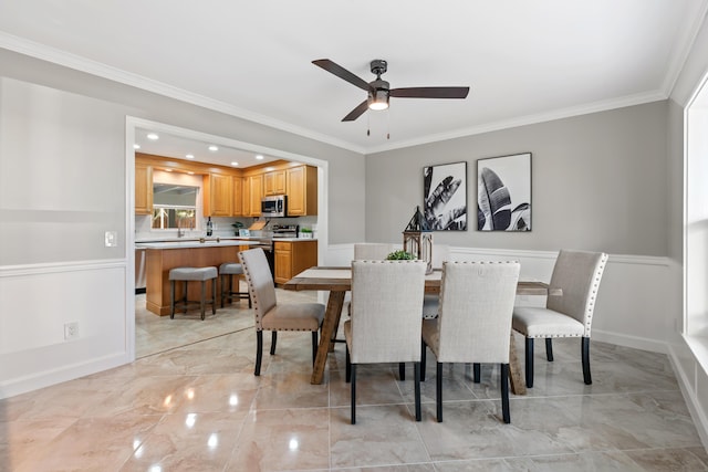 dining area featuring crown molding and ceiling fan