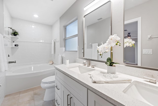 full bathroom with tiled shower / bath, vanity, toilet, and tile patterned flooring