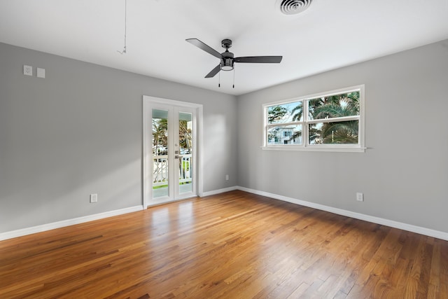 spare room featuring wood-type flooring and ceiling fan