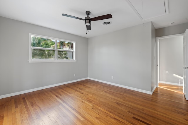 spare room featuring hardwood / wood-style floors and ceiling fan