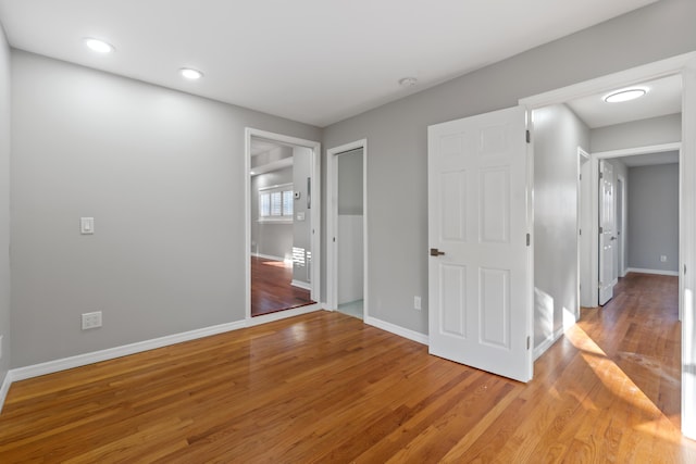 unfurnished bedroom featuring hardwood / wood-style flooring