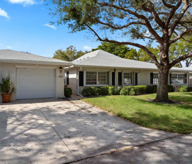 ranch-style home featuring a garage and a front yard