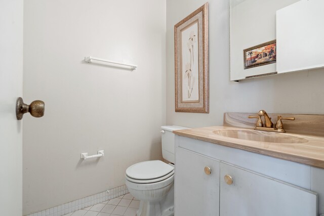 kitchen with sink, tasteful backsplash, light tile patterned floors, white refrigerator, and white cabinets