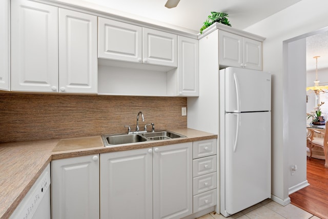 kitchen featuring white cabinetry, white appliances, sink, and decorative backsplash