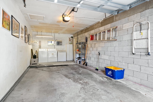 garage with a garage door opener, washer and dryer, and refrigerator