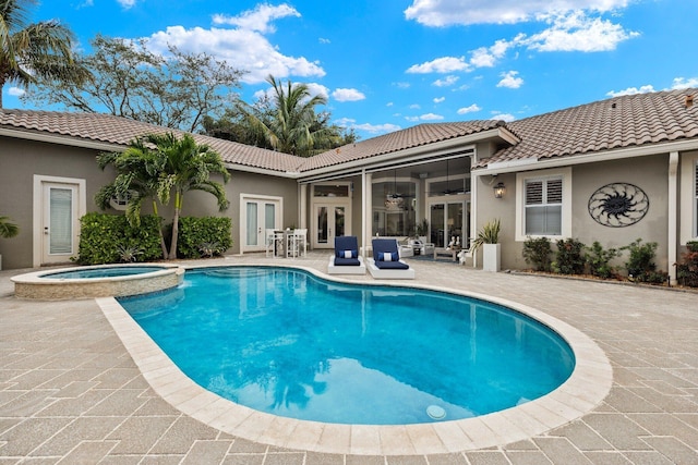 view of swimming pool with a patio area, french doors, ceiling fan, and an in ground hot tub