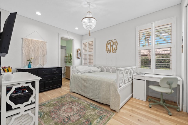 bedroom featuring light hardwood / wood-style floors and a notable chandelier