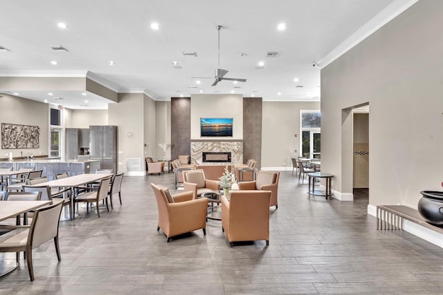 living room with hardwood / wood-style flooring, crown molding, and ceiling fan