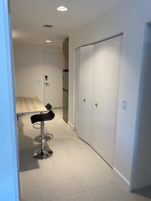 corridor featuring light tile patterned flooring