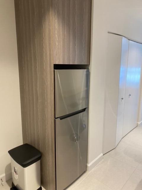 kitchen featuring light tile patterned floors and stainless steel refrigerator