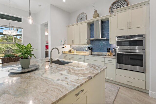 kitchen with light stone counters, stainless steel fridge with ice dispenser, and tasteful backsplash