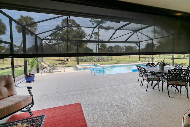 view of swimming pool with a patio, a jacuzzi, and glass enclosure