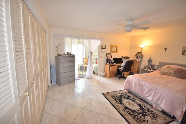 tiled bedroom with ceiling fan