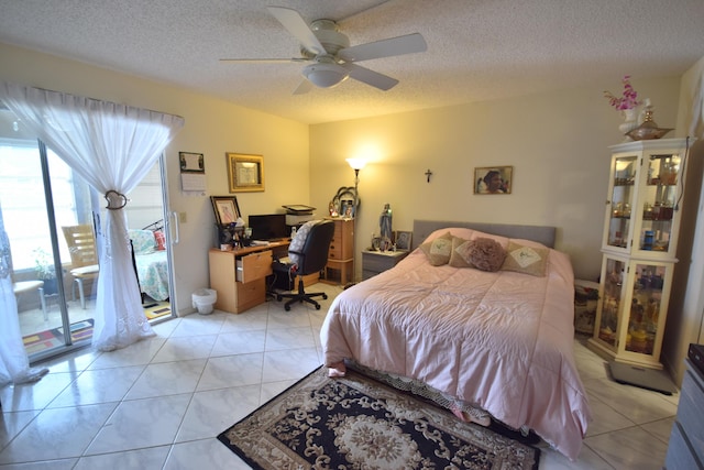 tiled bedroom with ceiling fan, a textured ceiling, and access to outside