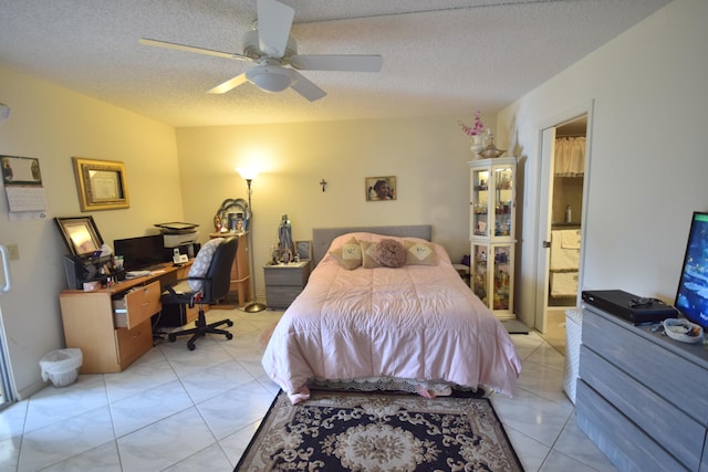 tiled bedroom with ceiling fan, connected bathroom, and a textured ceiling