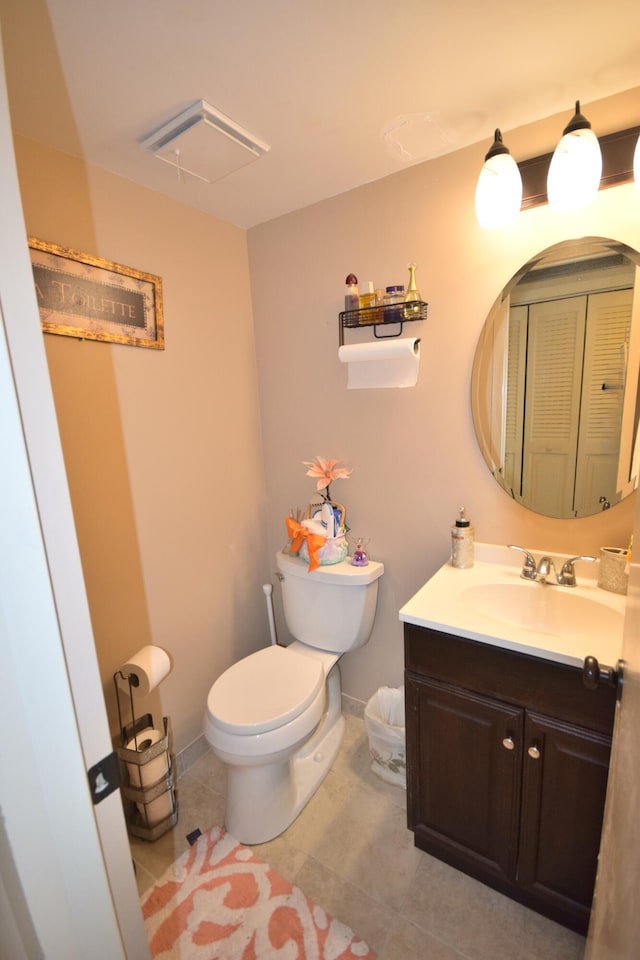 bathroom featuring tile patterned floors, vanity, and toilet