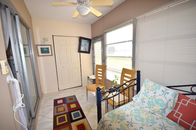 tiled bedroom with a closet and ceiling fan