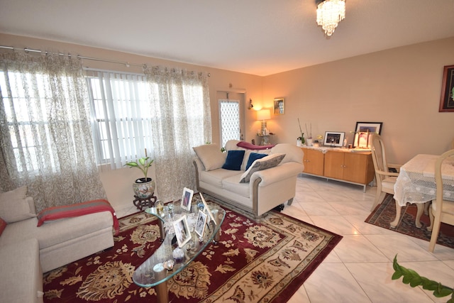 living room featuring an inviting chandelier and light tile patterned flooring