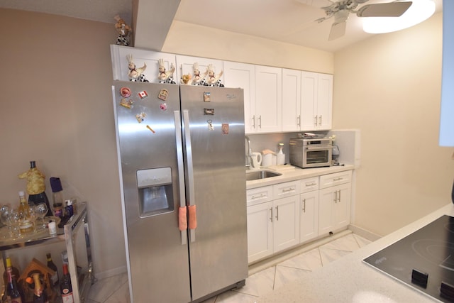 kitchen featuring stainless steel refrigerator with ice dispenser, ceiling fan, black electric cooktop, and white cabinets