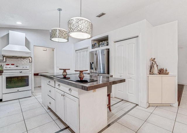 kitchen with stainless steel fridge with ice dispenser, a kitchen island, custom range hood, electric stove, and white cabinets