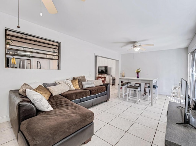 tiled living room with ceiling fan