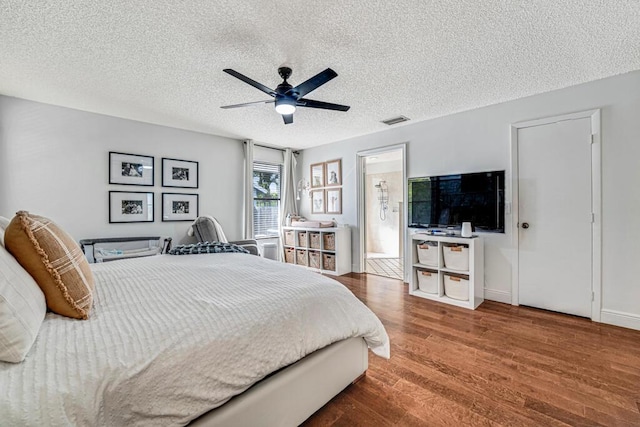 bedroom with hardwood / wood-style flooring, ceiling fan, and a textured ceiling