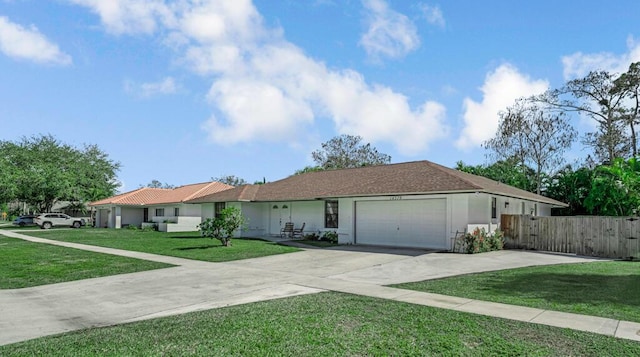 single story home featuring a garage and a front lawn