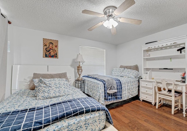 bedroom featuring hardwood / wood-style flooring, a textured ceiling, and ceiling fan