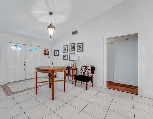 tiled foyer with vaulted ceiling