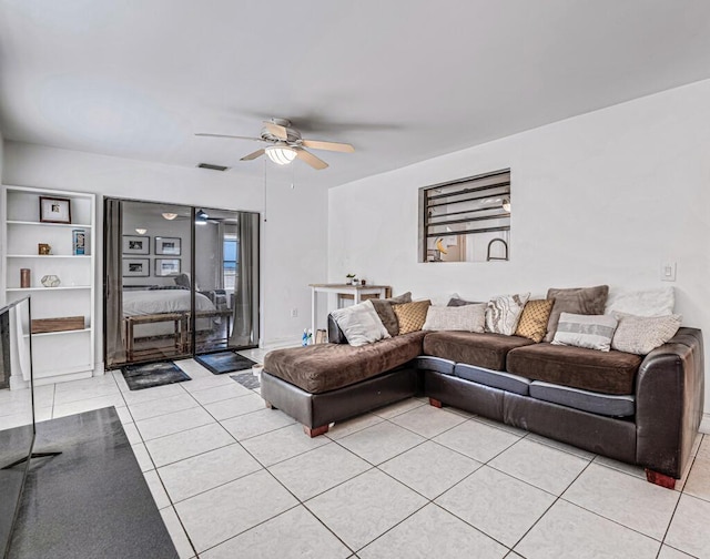 tiled living room featuring ceiling fan